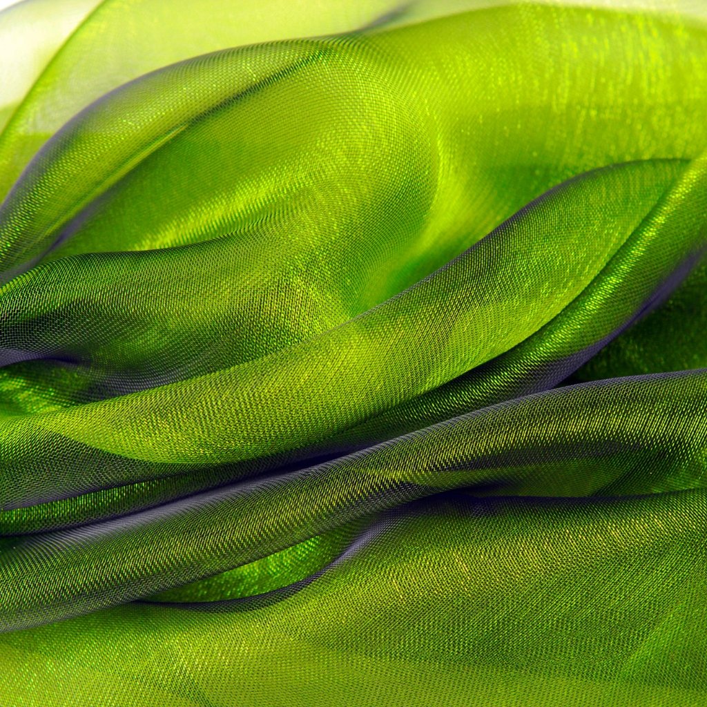 A close-up view of vibrant lime-green organza fabric, softly folded and layered to show its sheer, delicate texture and sheen.