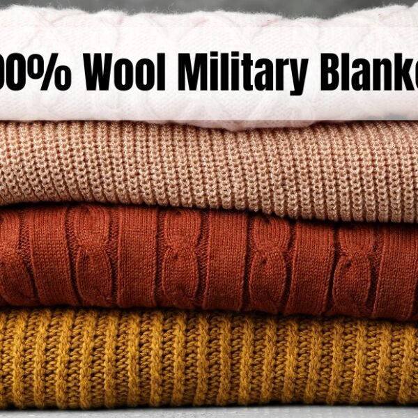 A neatly stacked pile of knitted wool blankets in four colors (pale pink, light brown, orange-brown, and mustard) resting on a gray surface with a plain dark backdrop. The top banner reads “100% Wool Military Blanket.