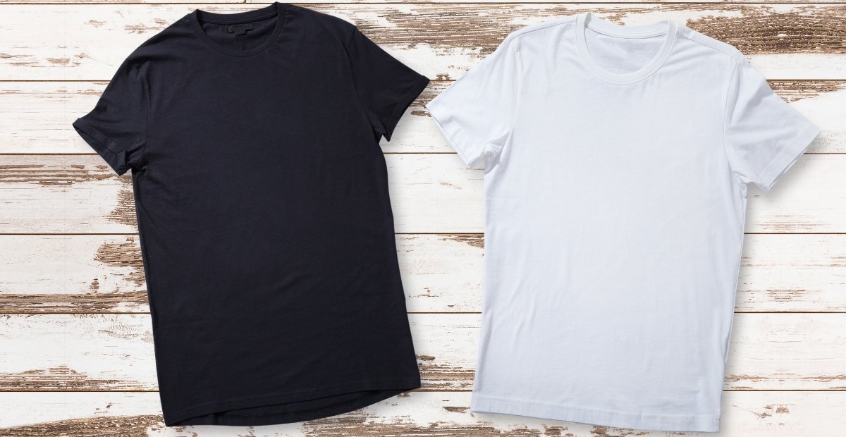 Best Merino Wool T-Shirts: Guide to Comfort & Performance Two plain t-shirts laid flat on a whitewashed wooden surface; one dark navy or black shirt on the left and a light gray shirt on the right. Best Merino Wool T-Shirts