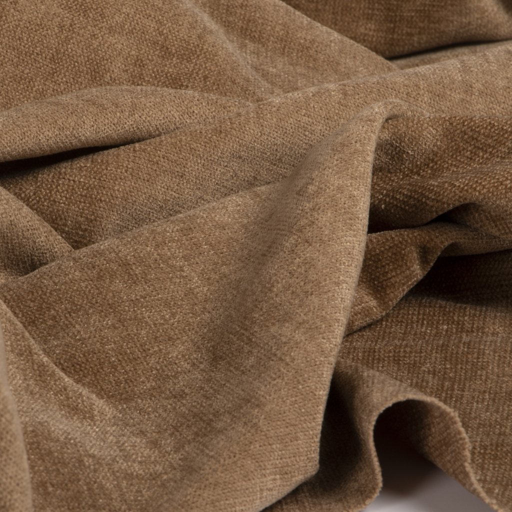  Close-up of a brown, textured fabric with soft folds and wrinkles.