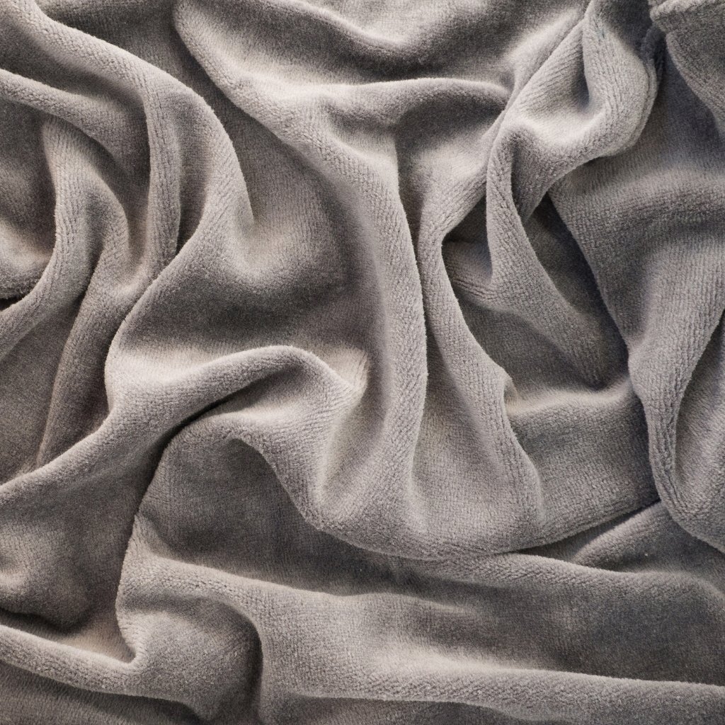 Close-up view of soft gray fabric with smooth, flowing folds and subtle texture.