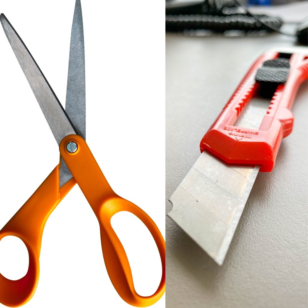 How to Sew Organza Fabric Like a Pro: Essential Sewing Tips 13 Close-up of bright orange handled scissors and a red utility knife with a partly extended blade.