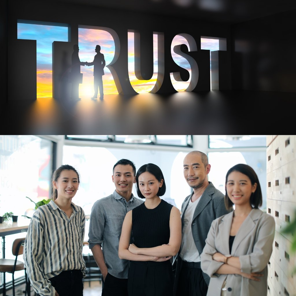 A bold, three-dimensional word 'TRUST' with a sunrise silhouette in the letters; below, a diverse group of professionals stands together in a modern office.