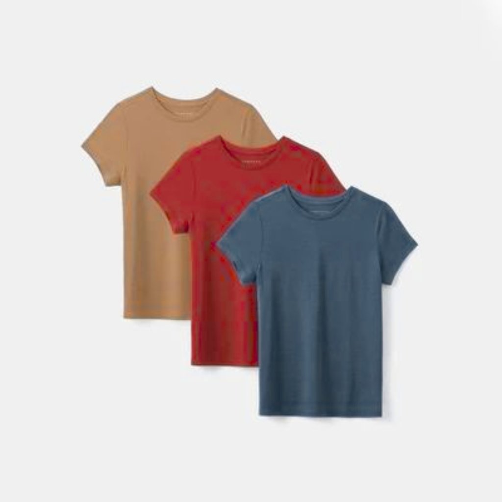 Three plain short-sleeve t-shirts in beige, red, and blue layered in a staggered arrangement.