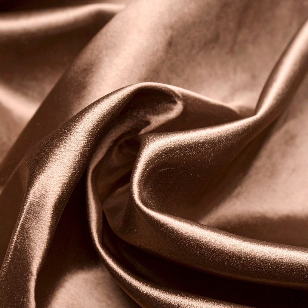 Close-up of silky satin organza fabric with soft folds and a subtle sheen, showing smooth texture and delicate drape.