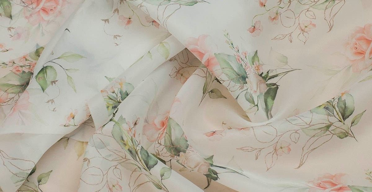 Floral Organza Fabric: Stunning Ideas for Dresses and Decor A close-up view of lightweight fabric with a delicate floral pattern in soft pinks, greens, and creams. Floral Organza Fabric
