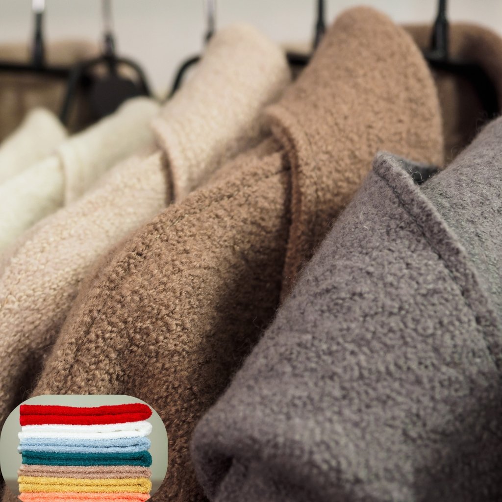 Sheep Wool Clothing: Natural Warmth and Timeless Style 17 Rows of soft, fluffy towels in neutral colors (beige, tan, gray) hanging on racks with a small stack of colorful towels in the corner.
