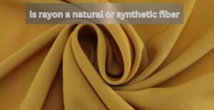 Close-up of soft yellow rayon fabric with text asking if rayon is a natural or synthetic fiber.