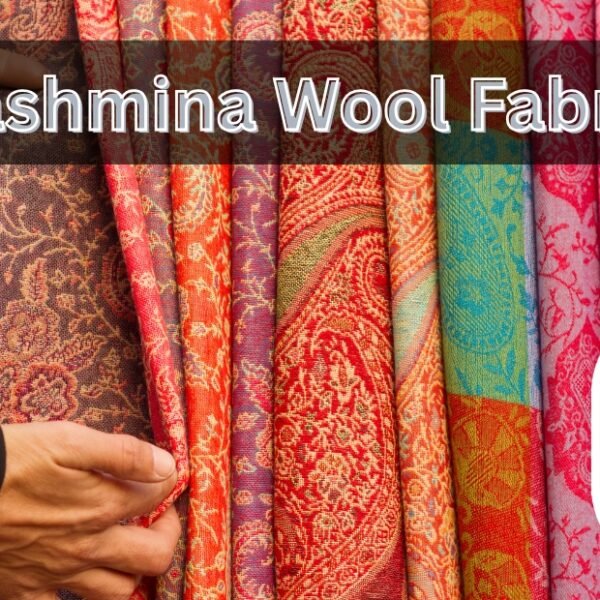 A row of colorful pashmina wool fabrics hanging in a shop, with a person pinching a red patterned textile. The image includes a small circular inset showing folded fabrics in beige and blue tones.