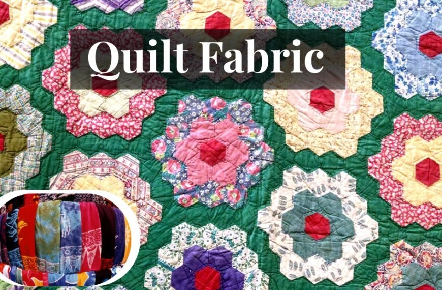 A colorful quilt made of numerous hexagonal starburst blocks arranged on a green background, featuring bright center squares in red and pink hues. A small circular inset shows a close-up of assorted striped and solid fabric strips in blue, red, orange, and purple, bundled together.
