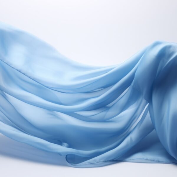 A light, airy piece of rayon chiffon fabric in soft sky-blue, intricately draped and flowing with gentle folds against a pale background.