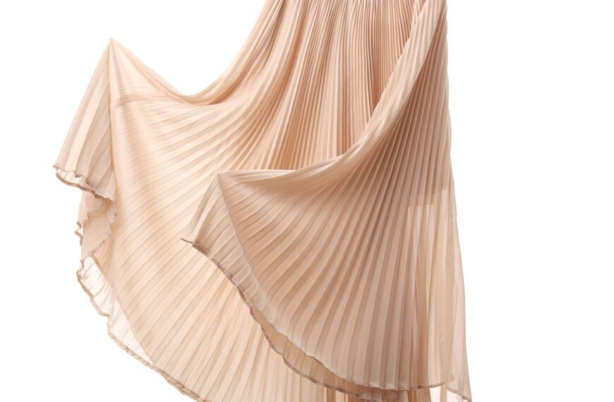 flowing rayon fabric skirt in soft champagne color with deep pleats cascading in a diagonal and graceful drape"