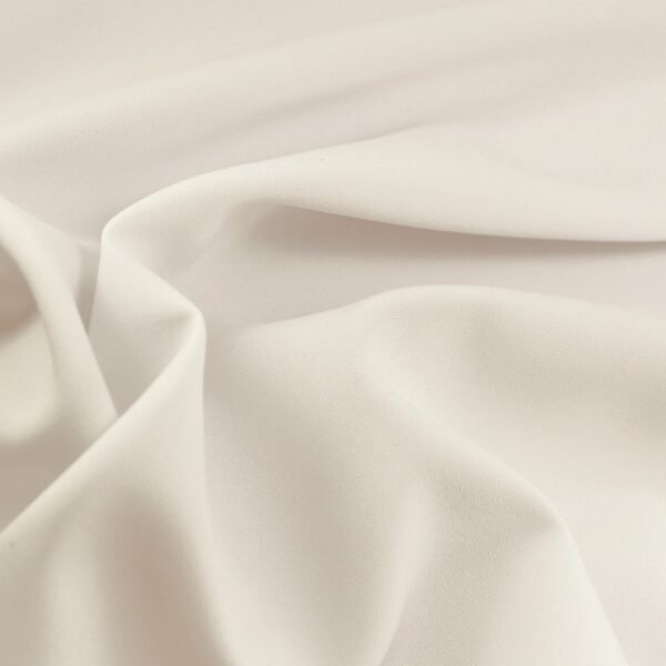 "Close-up of smooth, white rayon lawn fabric with soft folds and a matte finish."