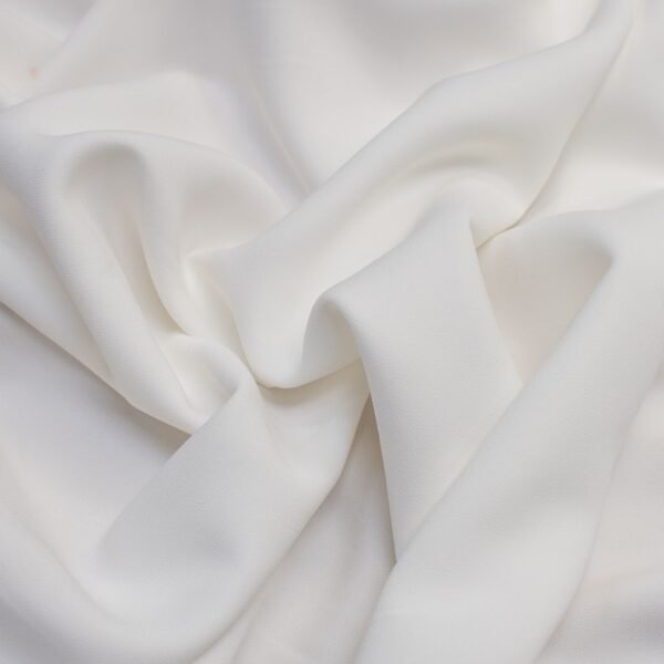 Close-up image of smooth, white Rayon Poplin fabric with soft, even weave and gentle folds."