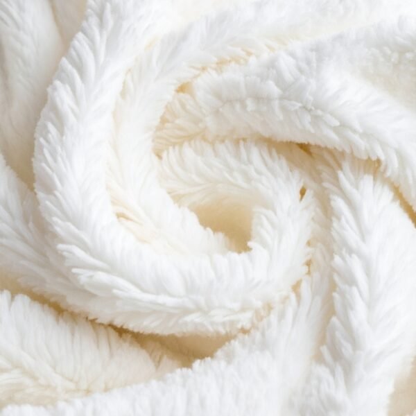 Close-up of soft, white, fluffy fabric with a plush, swirling texture.