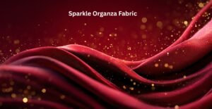 Close-up view of shimmering red and pink sparkle organza fabric with gold specks and flowing waves. Sparkle Organza Fabric