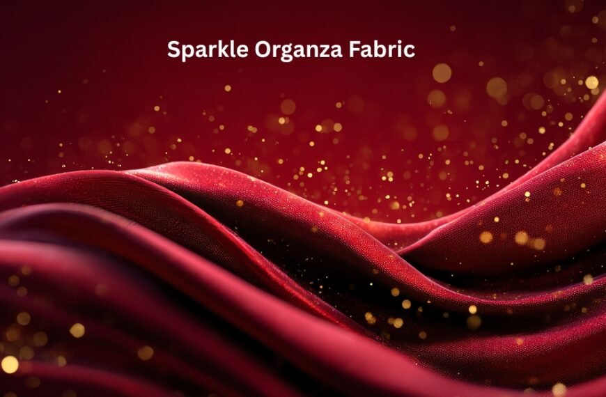 Close-up view of shimmering red and pink sparkle organza fabric with gold specks and flowing waves. Sparkle Organza Fabric