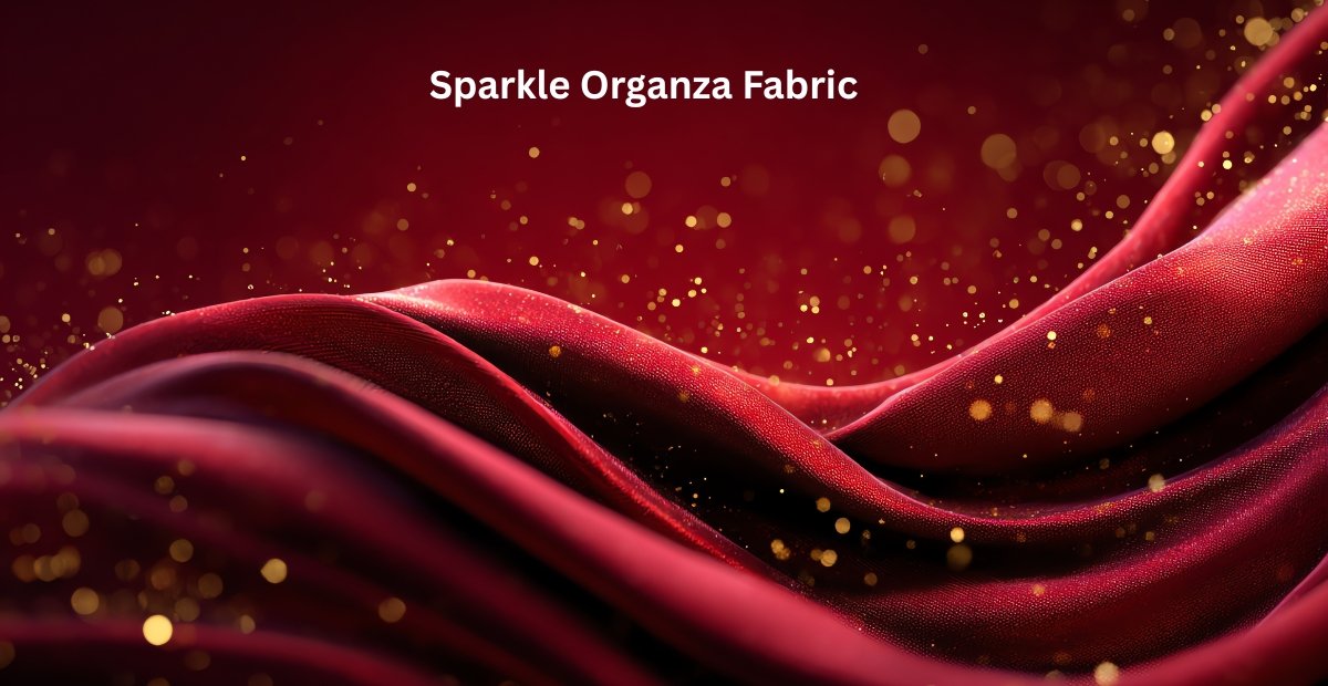 Close-up view of shimmering red and pink sparkle organza fabric with gold specks and flowing waves. Sparkle Organza Fabric