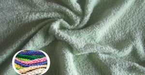 A close-up shot of a soft, plush terry wool fabric in a pale mint-green color, showing dense looped fibers and a cozy, textured surface. Inset at the bottom-left is a circular collage of colorful braided cords (pink, blue, green, purple, yellow, beige) providing a visual contrast.