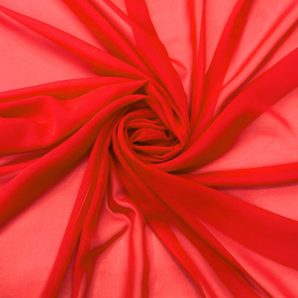 Bright red fabric swirled into a spiral, creating soft folds and a central knot.