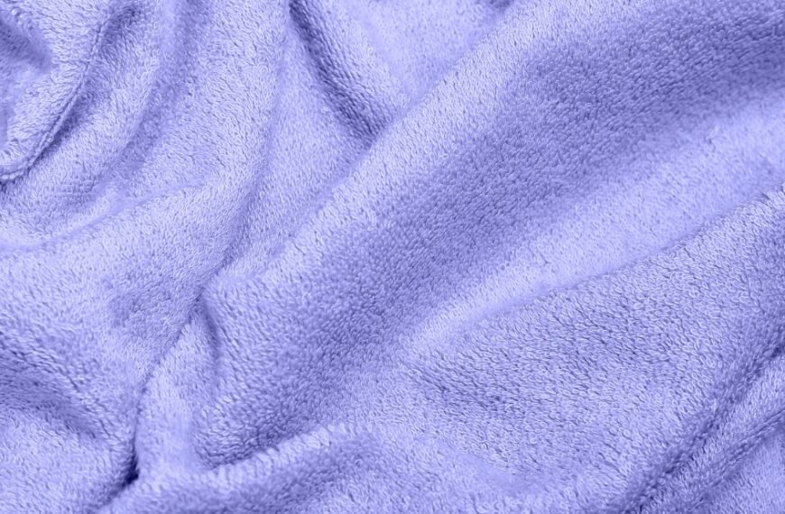A close-up view of soft, plush blue fabric with gentle folds and texture.