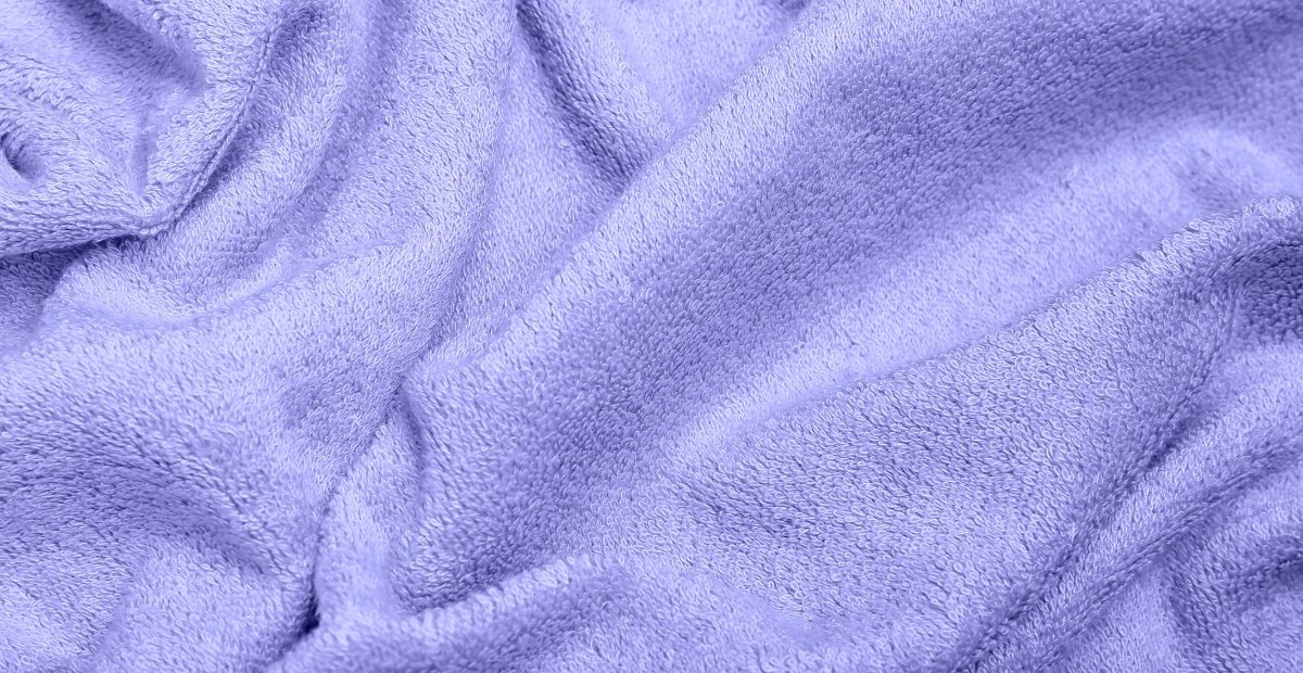 A close-up view of soft, plush blue fabric with gentle folds and texture.