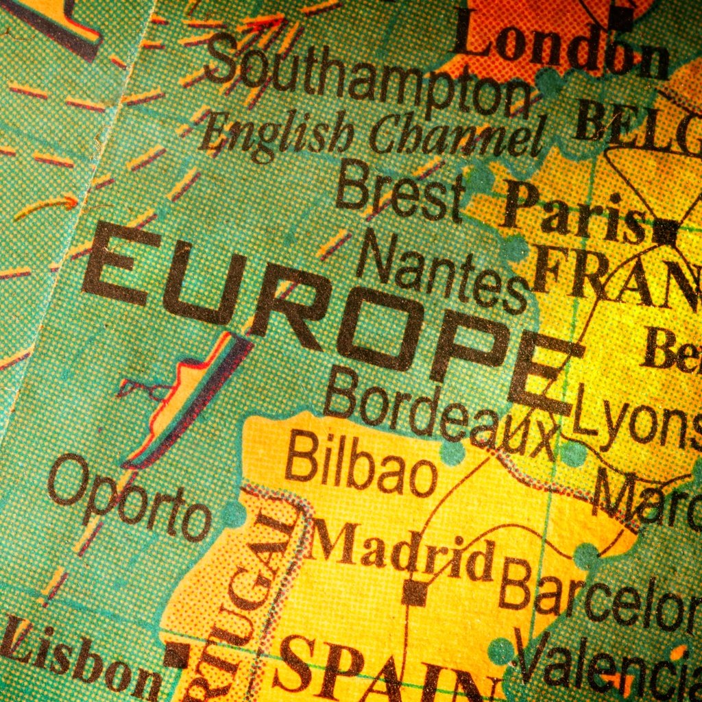 Close-up of a colorful European map showing cities like Bilbao, Madrid, and Barcelona with the word EUROPE prominently printed across the region.