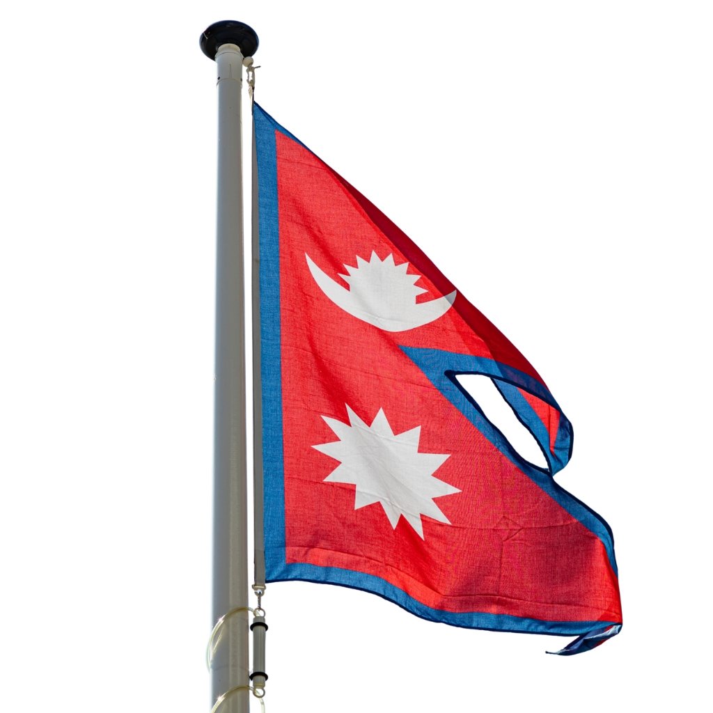 Red flag with blue border featuring white sun emblem, attached to a flagpole and fluttering in the wind."
Red flag with blue border featuring white sun emblem, attached to a flagpole and fluttering in the wind.