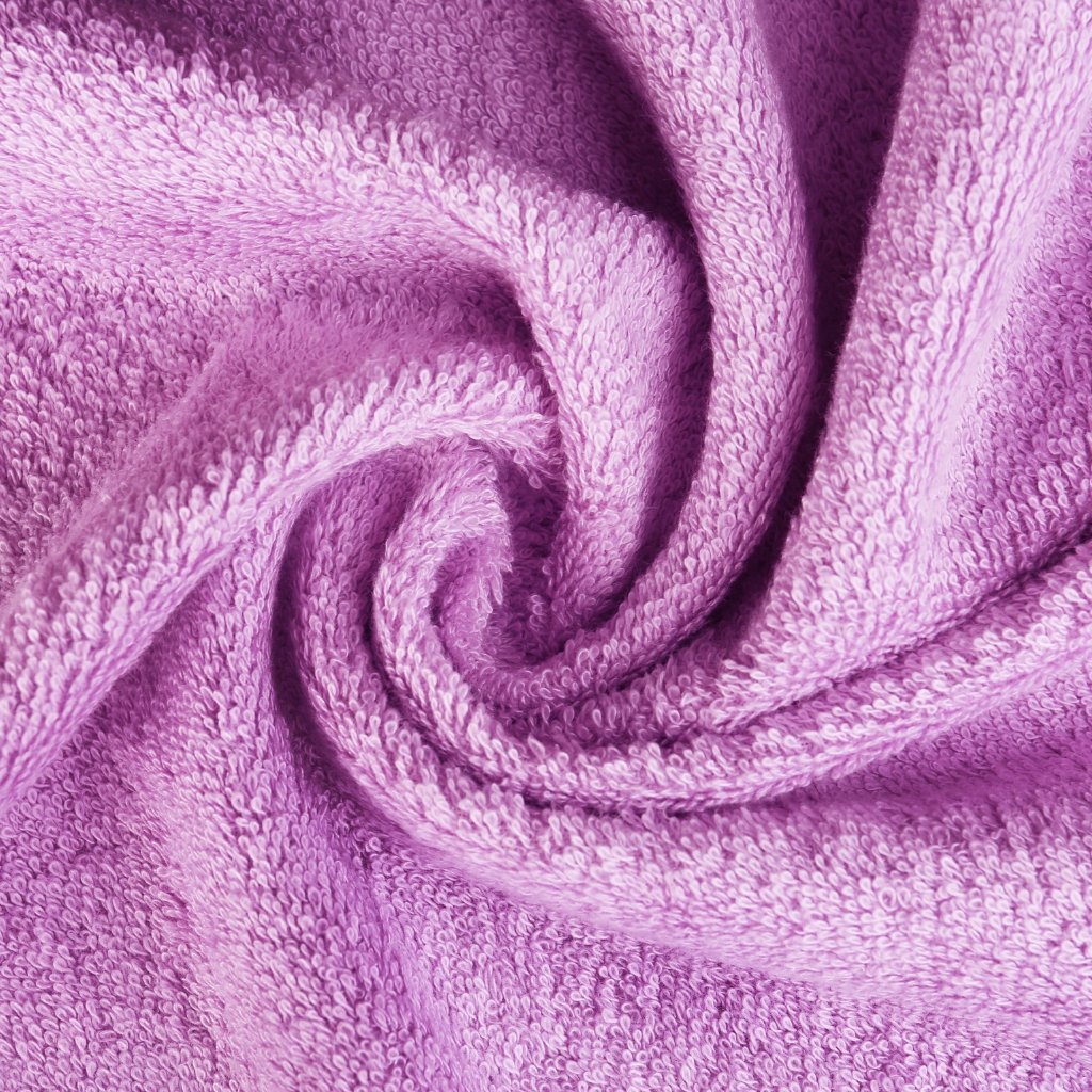Close-up of a lavender purple terry towel twisted into a spiral.