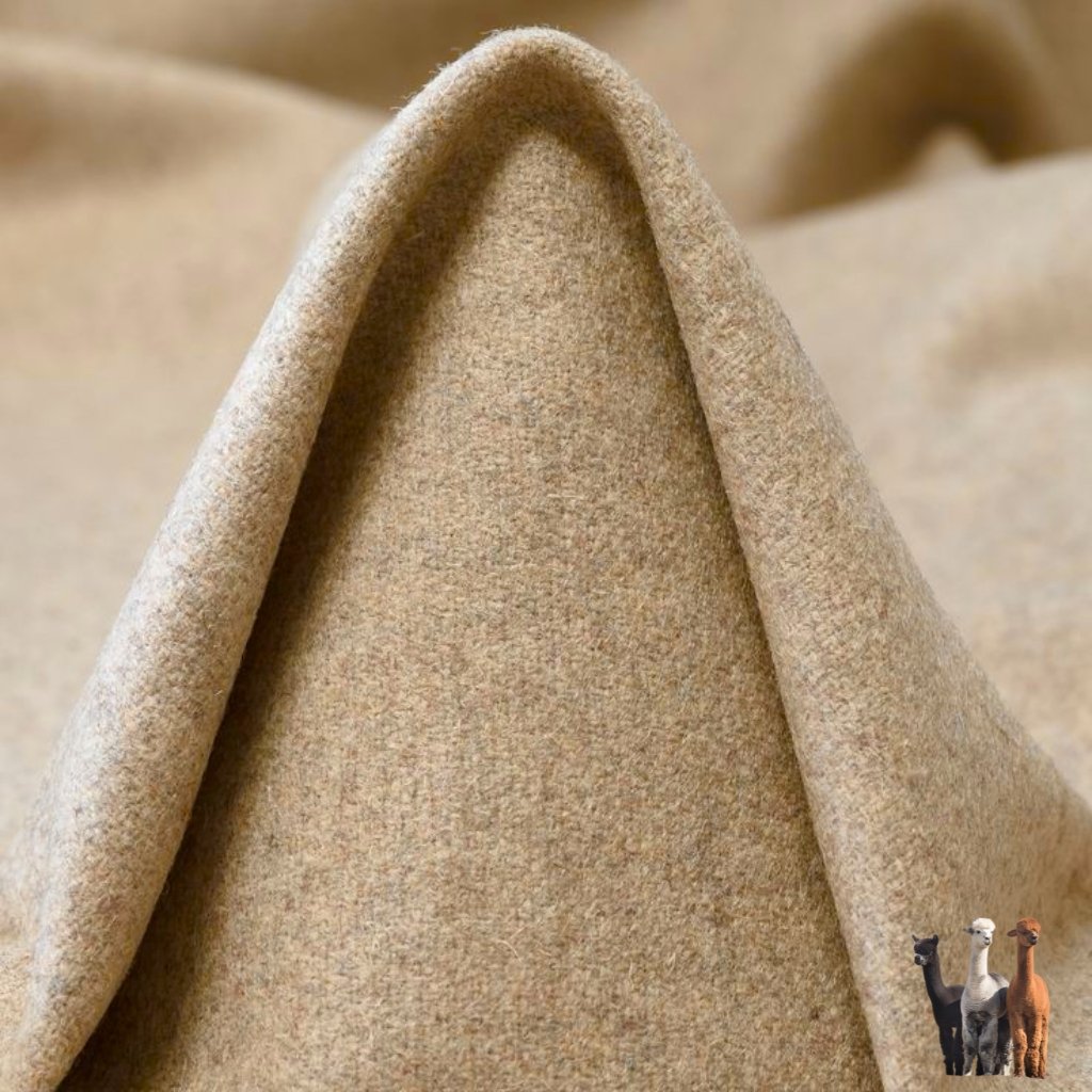 A close-up photo of a soft, tan camel-colored fabric folded into a peak, with four small standing llamas/camels in the bottom right corner.