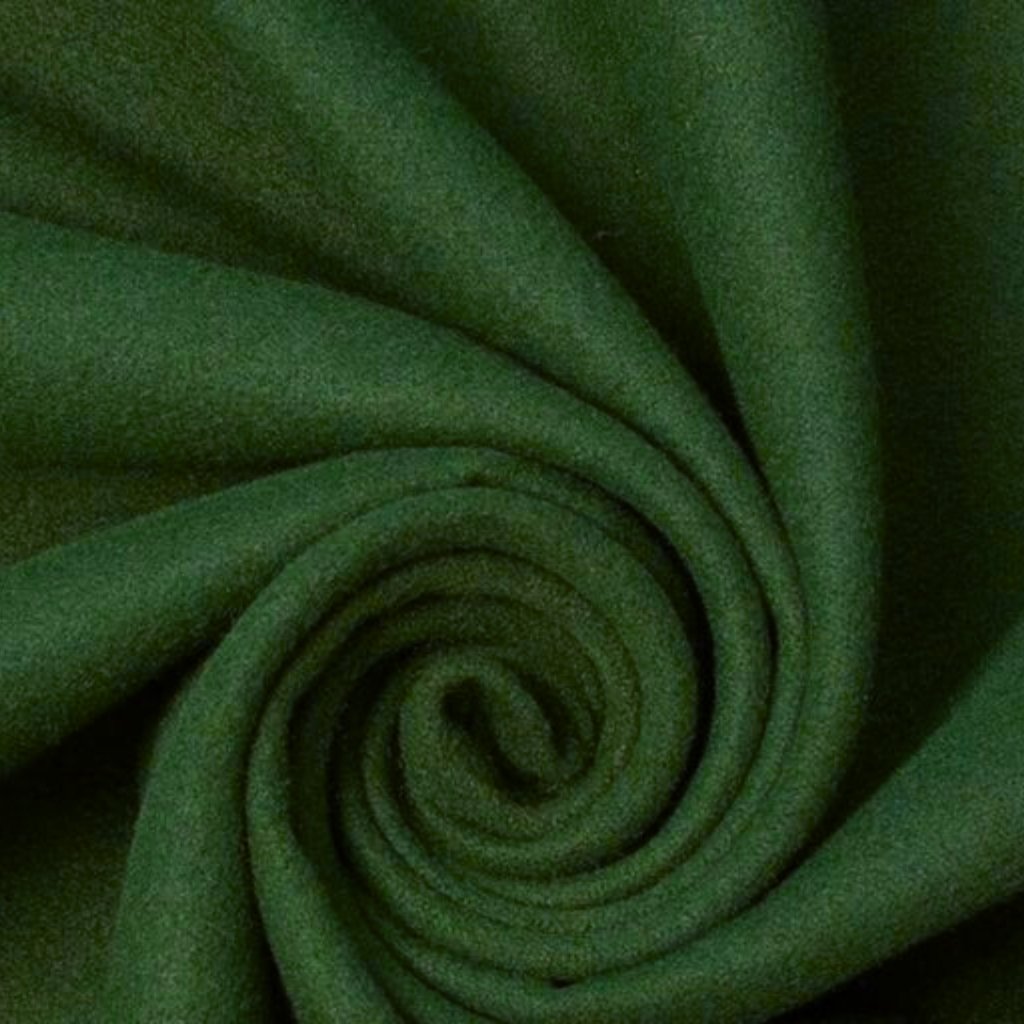 A close-up photo of dark green soft fabric folded into a spiral, creating concentric curves and a subtle texture.