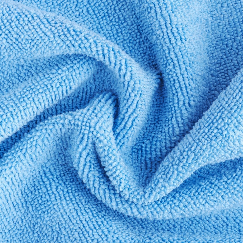 lose-up view of a soft, blue microfiber towel with textured loops. Easy Care and Wrinkle Resistance