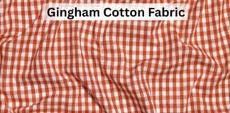Gingham Cotton Fabric Guide: Features, Uses, and Styling Tips Close-up view of gingham cotton fabric in a red and white checkered pattern with soft folds.