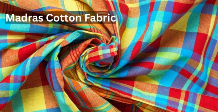 Close-up of colorful Madras cotton fabric with a plaid pattern, twisted into folds.