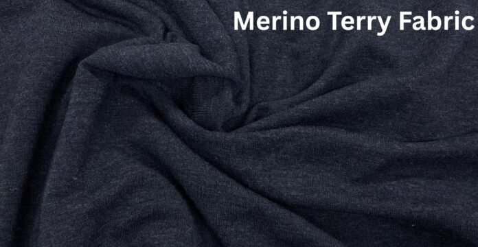 A close-up view of dark navy Merino terry fabric with soft folds and wrinkles.