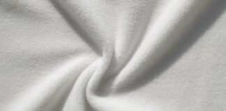 Microfleece Magic: Soft, Warm, and Perfect for Every Season A close-up of soft white fabric with gentle folds and twisted center.