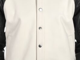 Close-up view of a light beige leather jacket with a front zipper, zippered chest pockets, and stitched panels.