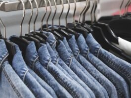 Overshirt Jacket: A Perfect Blend of Modern Style & Comfort A row of denim jackets hanging on black hangers along a clothing rack.
