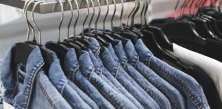 Overshirt Jacket: A Perfect Blend of Modern Style & Comfort A row of denim jackets hanging on black hangers along a clothing rack.