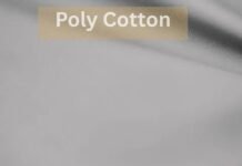 What is Poly Cotton Fabric? What to know before buying A close-up image of smooth poly cotton What Is Poly Cotton Fabric?fabric with a beige label reading “Poly Cotton,” illustrating textile texture for discussing topics like does polyester make you sweat'what is poly cotton fabric