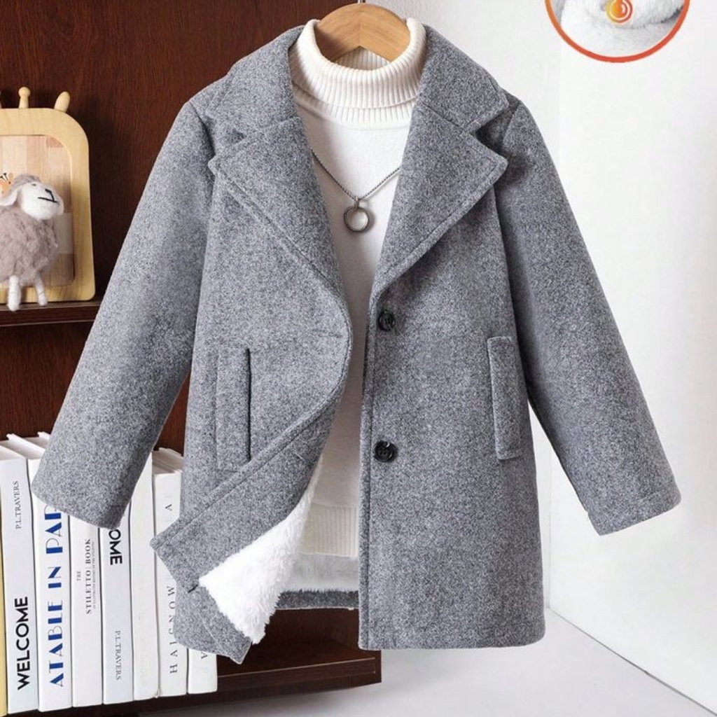 Felted Merino Fabric: Premium Softness for Cozy Elegance 10 A gray wool coat with a large lapel displayed on a wooden hanger over a white knit turtleneck; the coat has two front pockets and a fluffy lining peeking out from the bottom.