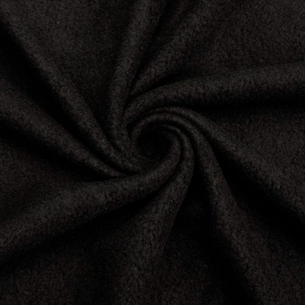 A close-up of dark, black fabric twisted into a spiral/folded pattern, revealing soft, plush texture.