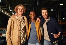 Top Track Jackets: Style, Comfort, and Performance Combined Three smiling young men standing together indoors at a recreation venue, arms around each other. Track Jackets