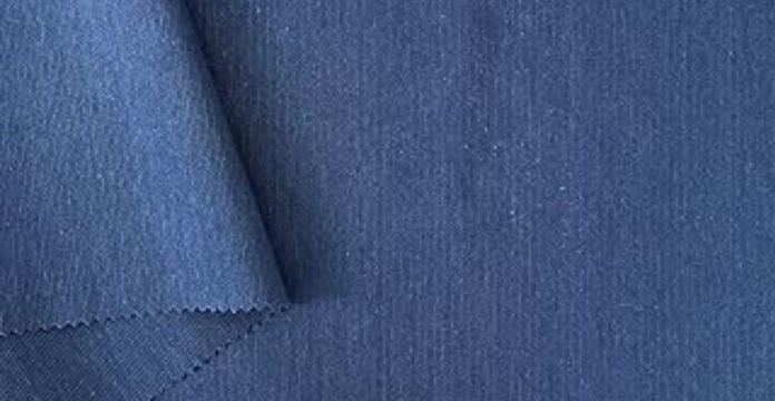 Blue polyester fabric close-up showing its smooth texture, used to illustrate discussions about “does polyester make you sweat”.What Is Cotton Dobby Fabric?what is cotton dobby fabric