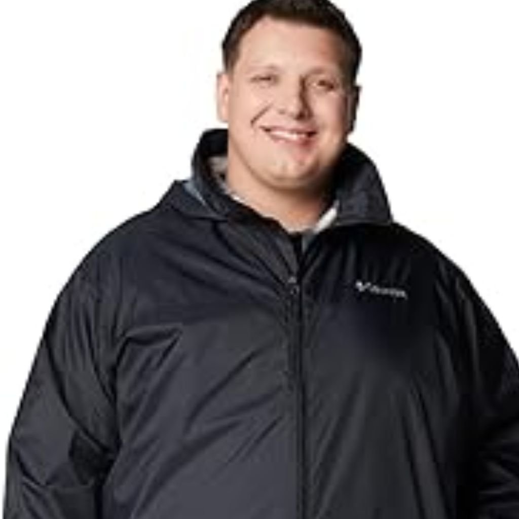 Waterproof or Water-Resistant Puffers: What You Should Know 15 A man wearing a color-blocked puffer jacket with a beige hood and shoulders, green body, and black sleeves, standing against a plain white background.Waterproof or Water-Resistant Puffers