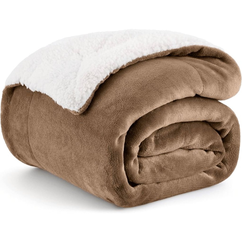 A folded brown plush blanket with a white fluffy underside partially visible. Microfleece Magic