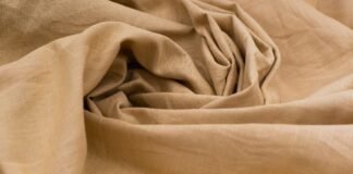 Does Cotton Fabric Pill? The Truth About Cotton’s Durability Close-up of beige polyester fabric with soft folds and texture, illustrating the question — does polyester make you sweat during wear.Does Cotton Fabric PillDoes Cotton Fabric Pill