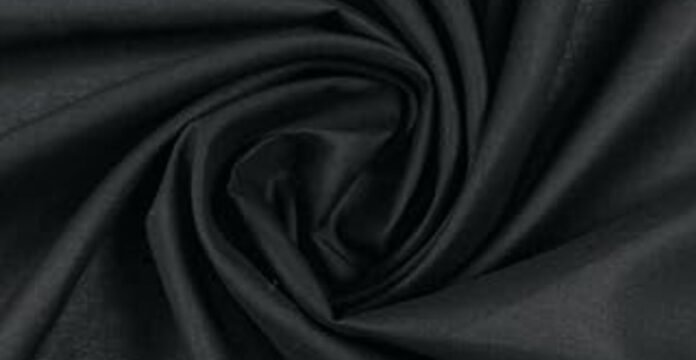 Close-up of black polyester fabric showing its smooth texture — illustrating the topic “does polyester make you sweat.”what is cotton lawn fabric