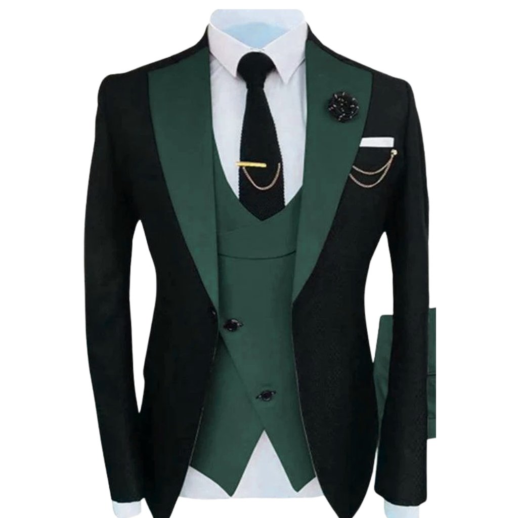 A stylish three-piece men's suit in black and dark green with a matching green waistcoat, white shirt, black tie, and decorative accessories (lapel pin and pocket chain).