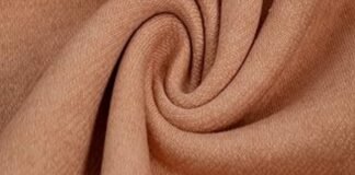 What Is Brushed Cotton Fabric? Benefits, Types & Best Uses A close-up view of a soft, tan-colored polyester fabric twisted into a swirl, often used to illustrate questions like does polyester make you sweat due to its texture and weave.what is brushed cotton fabricwhat is brushed cotton fabric